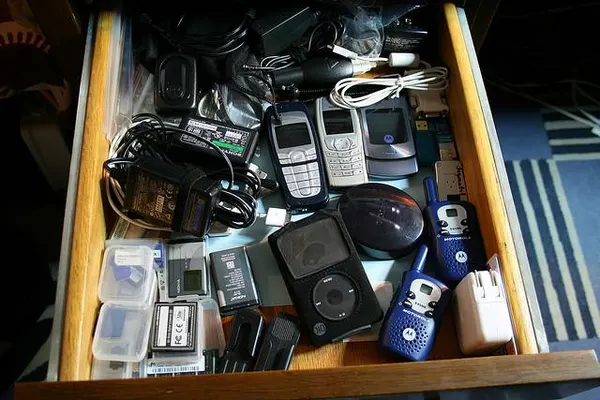 drawer of old electronics and cables - 4 In 10 Of Us Are Experiencing 'Extreme Gadget Obesity'