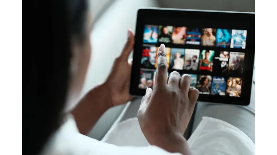 person watching Apple TV+ on tablet - Your Guide to Streaming Services: What, Where & How