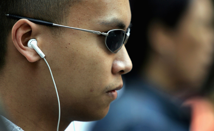 person wearing earbuds - What's that? How earbuds can wreck your hearing (especially for ...